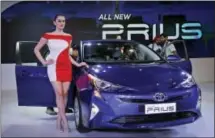  ?? ALTAF QADRI — THE ASSOCIATED PRESS FILE ?? A model poses next to Toyota’s fourth-generation Prius hybrid car at the Auto Expo in Greater Noida near New Delhi, India.