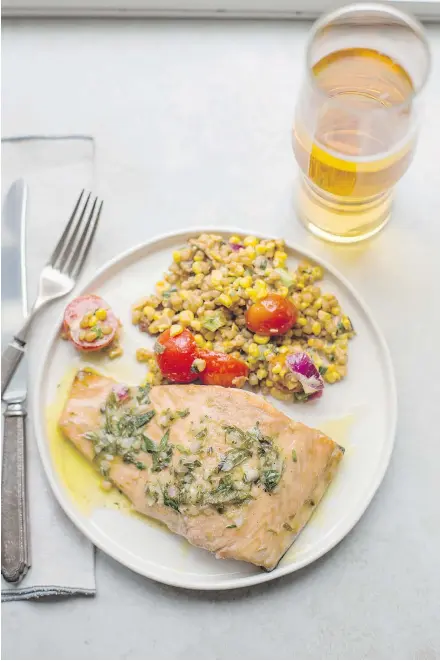  ?? — THE ASSOCIATED PRESS ?? Salmon is seared, then roasted and topped with a tasty tarragon vinaigrett­e.