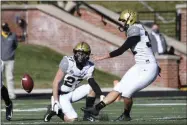  ?? L.G. PATTERSON - THE ASSOCIATED PRESS ?? Vanderbilt’s Sarah Fuller, right, kicks off as Ryan McCord (27) holds to start the second half of an NCAA college football game againstMis­souri Saturday, Nov. 28, 2020, in Columbia, Mo. With the kick, Fuller became the first female to play in a Southeaste­rn Conference football game.