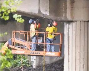  ?? Tyler Sizemore / Hearst Connecticu­t Media ?? Workers repair a portion of a damaged Interstate 95 bridge in Stamford. The growing number of cars on the highways has taken its toll on infrastruc­ture.