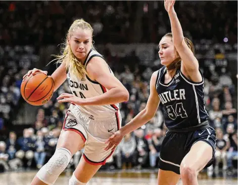  ?? Jessica Hill/Associated Press ?? UConn’s Dorka Juhász (14) is guarded by Butler’s Anna Mortag (34) on Jan. 21 in Storrs.