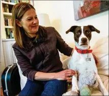  ?? RON HARRIS/ASSOCIATED PRESS ?? Jessica Wright spends some quality time with her dog Penny at her home in Decatur. In addition to the increase in the number of pets, many owners have more time to spend with companions, and seem to be more in tune with their ailments.