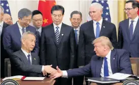  ?? Photo / AP ?? Chinese Vice Premier Liu He and Donald Trump shake hands.