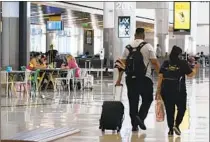  ?? Ashley Landis Associated Press ?? TRAVELERS at Los Angeles Internatio­nal Airport.