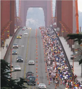  ?? Brant Ward / The Chronicle 2006 ?? San Francisco Marathon runners cross the Golden Gate Bridge in two lanes in 2006. This year, traffic was shut down northbound except for a single lane.
