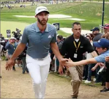  ?? Jamie Squire/Getty Images ?? Dustin Johnson gave the fans something to cheer about late, but fell short with bogeys on Nos. 16 and 17.