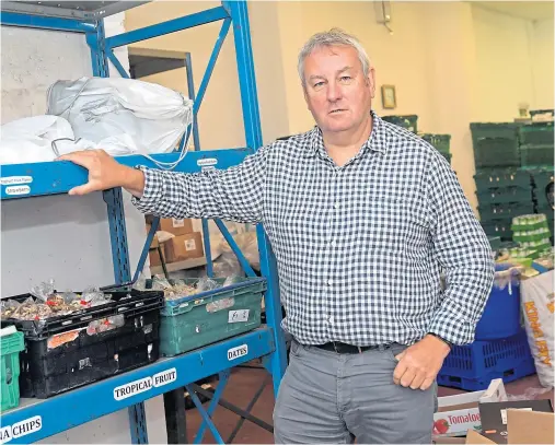  ?? Photograph by Kath Flannery ?? GROWING PROBLEM: Dave Kilgour, developmen­t work manager for CFINE, at the organisati­on’s foodbank.