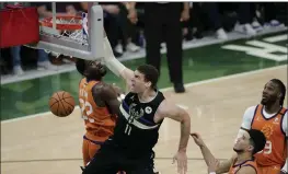  ?? AARON GASH — THE ASSOCIATED PRESS ?? Milwaukee Bucks center Brook Lopez (11) slam dunks over Phoenix Suns center Deandre Ayton (22), guard Devin Booker and forward Jae Crowder, right, during the second half of Game 6of the NBA Finals on Tuesday in Milwaukee.