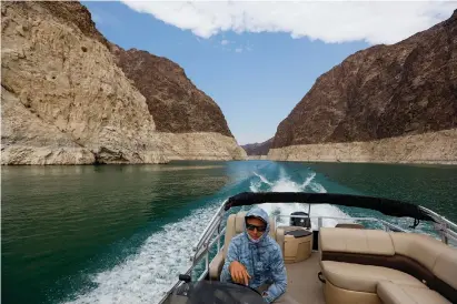  ?? (Allen J. Schaben/Los Angeles Times/TNS) ?? ERIC RICHINS, owner of Big Water Boating, surveys water levels and fish on Lake Mead, where he has led tours for two years.