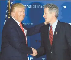  ?? STAFF PHOTO BY CHRISTOPHE­R EVANS ?? ROLE PLAYER: Donald J. Trump shakes hands with former Bay State U.S. Sen. Scott Brown in February.
