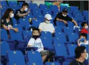  ?? (AP/Chiang Ying-ying) ?? Fans sit in the stands for a game at Xinzhuang Baseball Stadium in New Taipei City, Taiwan, on Friday. Up to 1,000 spectators are now allowed in the stands for baseball in Taiwan, but concession stands are still closed.