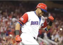  ?? Associated Press ?? The Dominican Republic’s Nelson Cruz reacts after hitting a three-run home run during the eighth inning of Saturday’s first-round World Baseball Classic game against the United State in Miami.