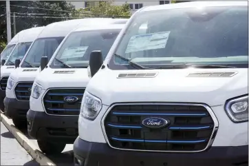  ?? MARTA LAVANDIER - THE ASSOCIATED PRESS ?? Ford E-Transit electric vans at a Ford dealership Jan. 23 in Hialeah, Fla. Ford plans to increase production this year.