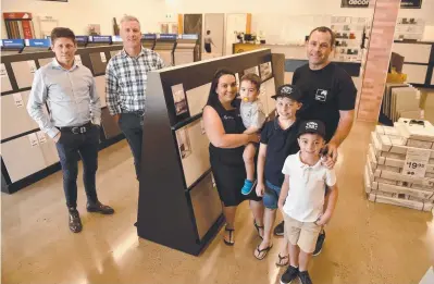  ?? Picture: EVAN MORGAN ?? NATURAL PROGRESSIO­N: Dan Place and Paul Dury from Knight Frank with Tamara and Dean Parfrey with Harry, 3, Billy, 10, and Charlie, 7, at their new Carpet Call business in Garbutt.