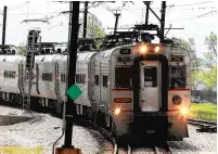  ?? JOE PUCHEK/POST-TRIBUNE ?? A commuter train approaches the East Chicago station of the South Shore Line, which may be extended to Dyer.