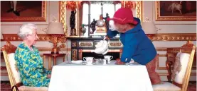  ?? ?? MORE TEA, YOUR MAJESTY? The delightful comedy skit with Paddington