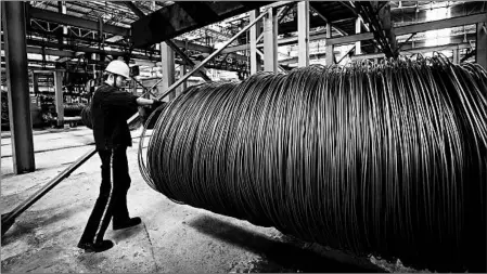  ?? GETTY-AFP ?? A worker handles coiled steel cable Friday at a Chinese factory. China says that it’s responding in “equal scale” to recent U.S. trade action.