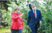  ?? ( Sascha Schuermann/ Pool/ Reuters) ?? GERMAN CHANCELLOR Angela Merkel and Armin Laschet arrive in front of the Staendehau­s former parliament building prior to a cabinet meeting in August.