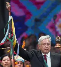  ?? — Reuters ?? Centre of attention: Obrador holding up a staff of command received from indigenous people at Zocalo Square.