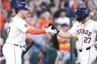  ?? (AP Photo/kevin M. Cox) ?? Houston Astros’ Jose Altuve (27) celebrates with Yainer Diaz, left, after scoring on a two-run double by Kyle Tucker Saturday during the seventh inning of a baseball game against the Texas Rangers in Houston.