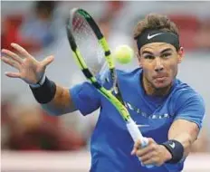  ?? Reuters ?? Rafael Nadal hits a backhand return to Karen Khachanov of Russia in the China Open second round yesterday.