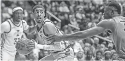  ?? BEN QUEEN/USA TODAY SPORTS ?? Iowa State guard Tyrese Haliburton drives while defended by West Virginia forward Oscar Tshiebwe on Feb. 5.