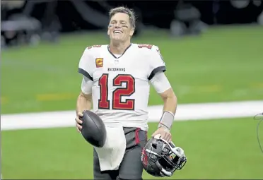  ?? BRETT DUKE / AP ?? Tampa Bay Buccaneers quarterbac­k Tom Brady smiles after a divisional round playoff game against the New Orleans Saints on Sunday in New Orleans. The Buccaneers won, 30-20.