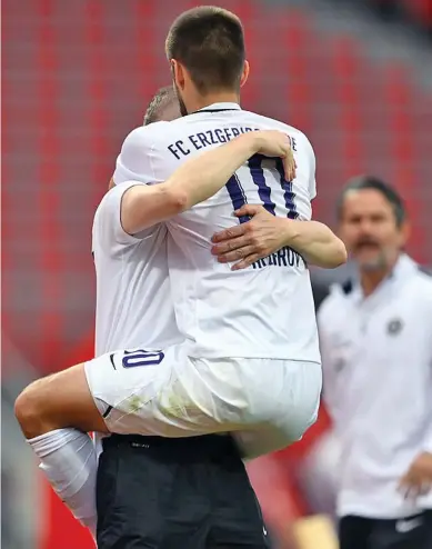  ??  ?? Dimitrijn Nazarov ran to the sideline after scoring and embraced team bus driver Thomas Romeyke. Photo: Daily Mail .Photo: BBC SPORTS