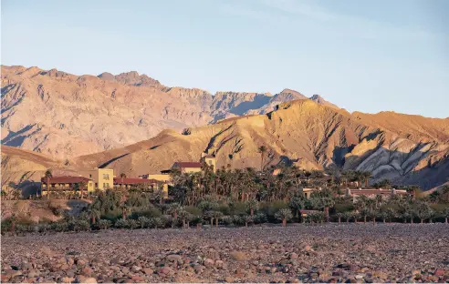  ?? PHOTOS BY BETH COLLER/THE NEW YORK TIMES ?? The Inn at Death Valley is shown in Death Valley National Park in California last month. Surrounded by date palms, the inn has a spring-fed pool and expansive views of the national park. The ancestral homelands of the Timbisha Shoshone, the area got its name from late-to-the-gold-rush miners in 1849.