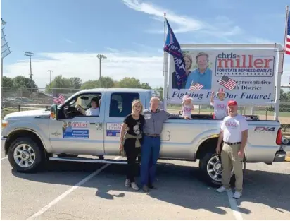  ?? FACEBOOK ?? U.S. Rep. Mary Miller and her husband, state Rep. Chris Miller, center, pose next to their pick-up truck in a campaign photo.