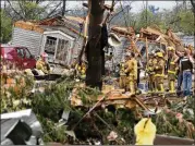  ?? DAN REILAND / EAU CLAIRE LEADER-TELEGRAM ?? Firefighte­rs work the site of damage after a tornado ripped through Prairie Lake Estates trailer home park just north of Chetek, Wis., on Tuesday. One man was killed, authoritie­s said.