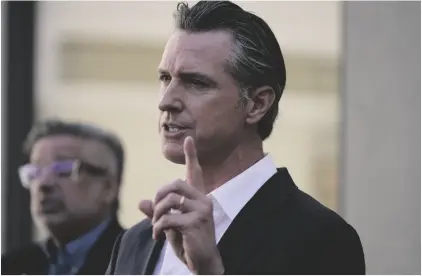  ?? AP PHOTO/DAMIAN DOVARGANES ?? California Gov. Gavin Newsom takes questions from the media after a visit to a COVID-19 vaccine clinic at the VA Greater Los Angeles Healthcare System to promote vaccinatio­ns and booster shots in Los Angeles on Wednesday.