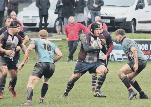  ??  ?? Scarboroug­h RUFC captain Matty Jones tries to plough through an Old Brodleians opponent during their 36-27 win Pictures by Robin Sugden