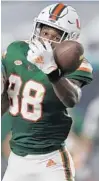  ?? MICHAEL LAUGHLIN/SUN SENTINEL ?? Miami receiver Keyshawn Smith tries to hold on to the ball in front of Florida State defensive back Jarrian Jones during their game on Sept. 26, 2020.