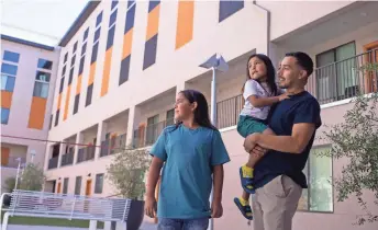  ?? SEAN LOGAN/THE REPUBLIC ?? Reynaldo Galindo, 31, stands with his sons, Royall, 4, and Myson, 11, at Urban Living on 2nd near Fillmore Street in downtown Phoenix on Monday.