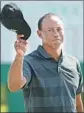  ?? Jamie Squire Getty Images ?? TIGER WOODS waves to the crowd after finishing his opening round of one-over-par 73.