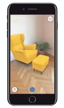  ?? VIA AP ?? Ikea’s augmented reality app IKEA Place, demonstrat­ed on an iPhone, allowis a user to superimpos­e virtual images over real-life settings. The app allows shoppers to see how furniture will look in their living room or other space before buying it. IKEA