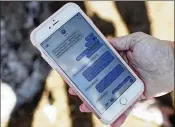  ?? BRYNN ANDERSON / ASSOCIATED PRESS ?? Alana Koer of Parkland shows text messages she got from her son Kai during the school shooting. Kai, 17, survived.