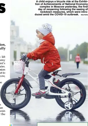  ?? REUTERS ?? A child enjoys a bicycle ride at the Exhibition of Achievemen­ts of National Economy complex in Moscow yesterday, the first day of reopening following the easing of lockdown measures, which were introduced amid the COVID-19 outbreak.