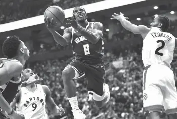  ?? Frank Gunn/The Canadian Press via AP ?? ■ Milwaukee Bucks guard Eric Bledsoe (6) drives to the net as Toronto Raptors forward Kawhi Leonard (2) attempts to defend on Sunday in Toronto.