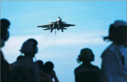  ?? LI TANG / FOR CHINA DAILY ?? A J-15 fighter jet approaches the recovery area of the CNS Liaoning at the end of a training flight.