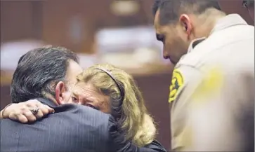  ?? Kent Nishimura
Los Angeles Times ?? OFFICER Mary O’Callaghan hugs attorney Robert Rico after the verdict was read. Rico said he planned to file a motion for a new trial because he thought jurors had based their decision on emotions, not evidence.