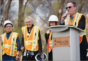  ??  ?? Left: Mayor Ted Clugston speaks during the sod turning event for the seniors centre on Tuesday. LaVerne Noble, councillor Julie Friesen, and councillor Celina Symmonds look on.