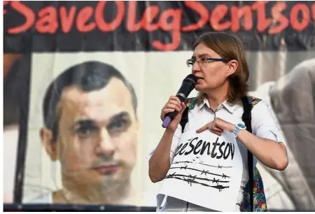  ?? — AFP ?? Plea for release: Natalia speaking during a rally in honour of her cousin pictured in the backdrop at Independen­ce Square in the Ukrainian capital of Kiev in this file picture.