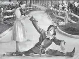  ?? MGM Studios ?? RAY BOLGER, always rubber-legged, with Judy Garland in “The Wizard of Oz.”
