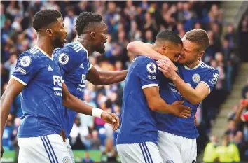  ?? AP ?? Leicester’s Youri Tielemans (second right) celebrates with teammate Jamie Vardy after scoring his side’s opening goal during the Premier League match against Manchester United yesterday.
