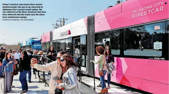  ?? [PHOTOS BY JIM BECKEL, THE OKLAHOMAN] ?? Friday’s streetcar open house drew several hundred people who got an up-close look at Oklahoma City’s newest transit option. The city rolled two of the three streetcars that have been delivered onto the tracks near the downtown maintenanc­e garage....