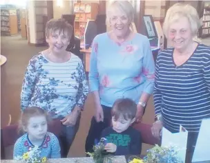  ??  ?? Macclesfie­ld Flower Club members, Hazel Dorey, Lynne Hibbert and Jackie Edwards, encourage children to make small flower arrangemen­ts