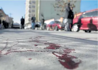  ?? Rahmat Gul, The Associated Press ?? Blood stains the ground at the scene where gunmen fired on a car in northern Kabul on Jan. 17, killing two women judges who worked for Afghanista­n's high court and wounding the driver, a court official said.