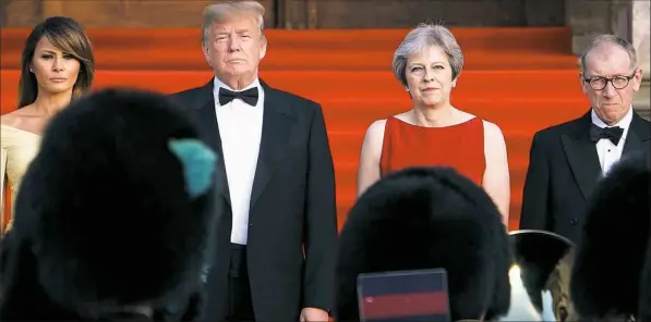  ?? Brendan Smialowski/AFP/Getty Images ?? Arriving for a black-tie dinner Thursday with business leaders at Blenheim Palace, west of London, are, from left, first lady Melania Trump, President Donald Trump, Britain’s Prime Minister Theresa May and Philip May, spouse of the prime minister.